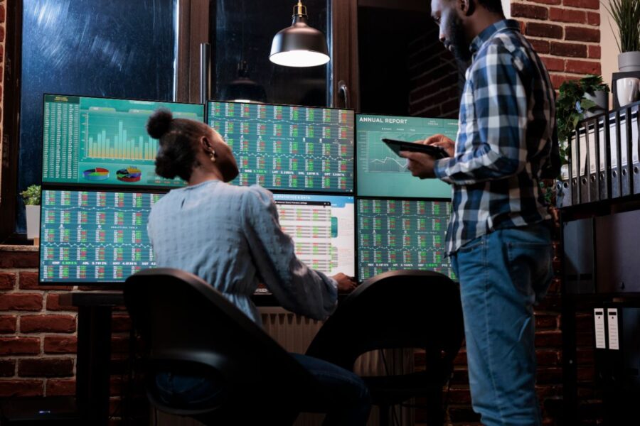 Crypto Trading Risk Management - crypto traders Infront of screens displaying a stock market chart and trading analysis